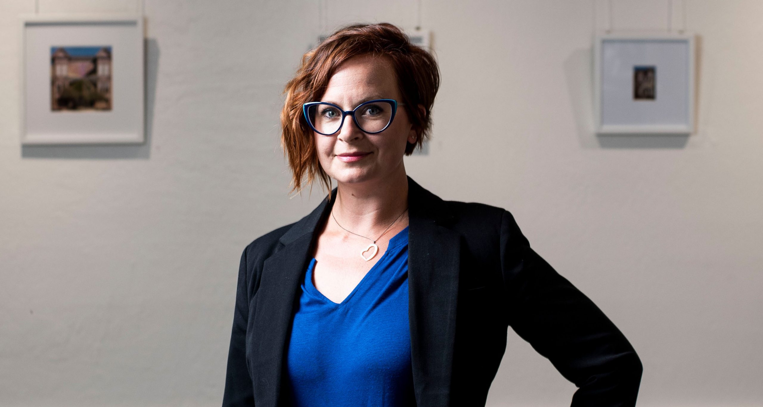Gallery director and visual artist Emily McEwan-Upright inside a contemporary fine art gallery space.