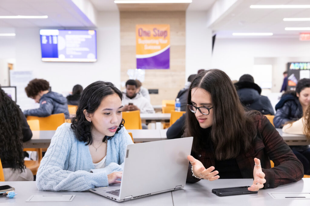 Students in a class looking at a computer