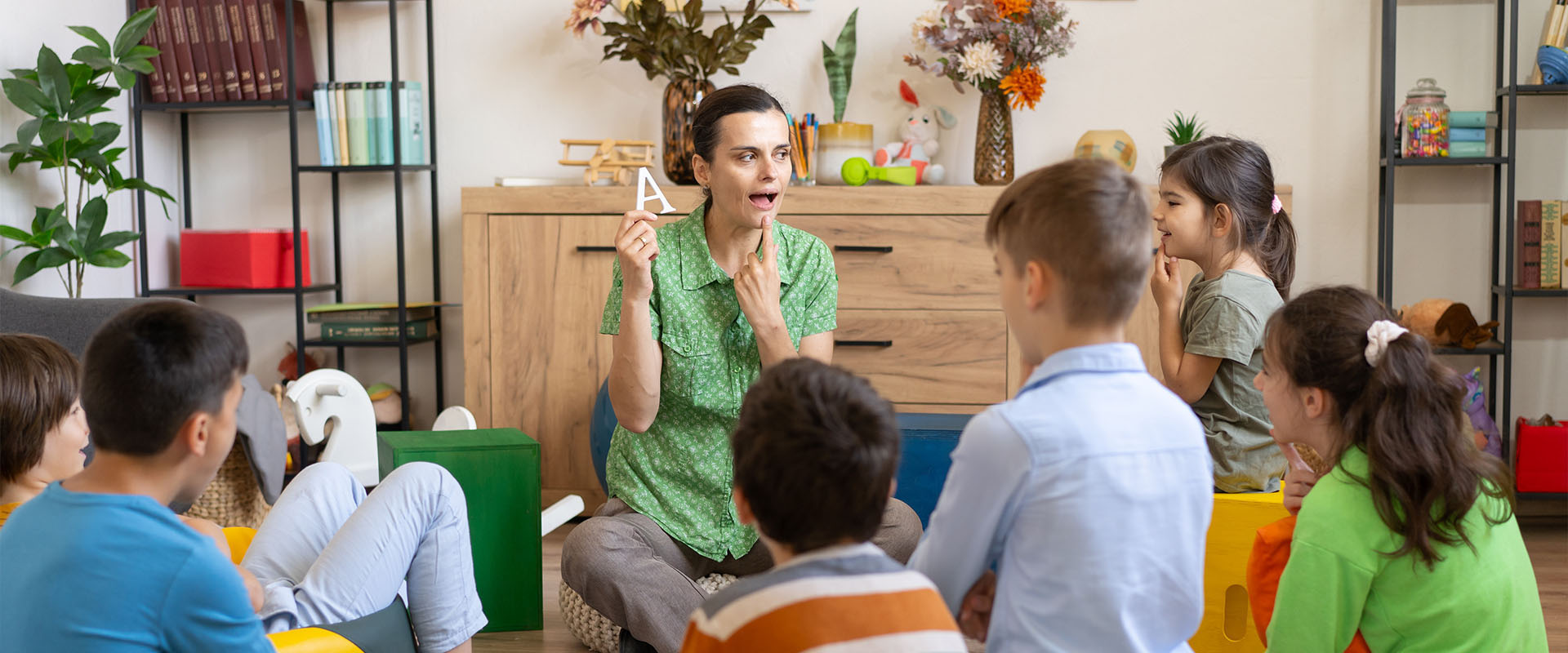 Speech therapist working with a group of children