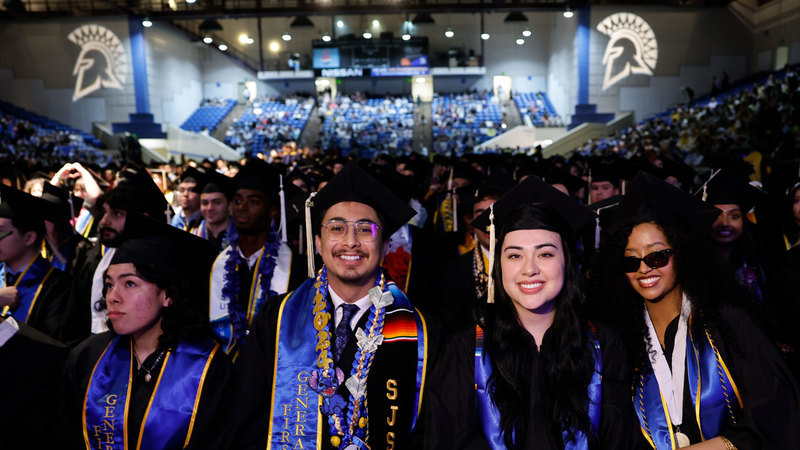 SJSU graduate students smile for a picture while celebrating their graduation day