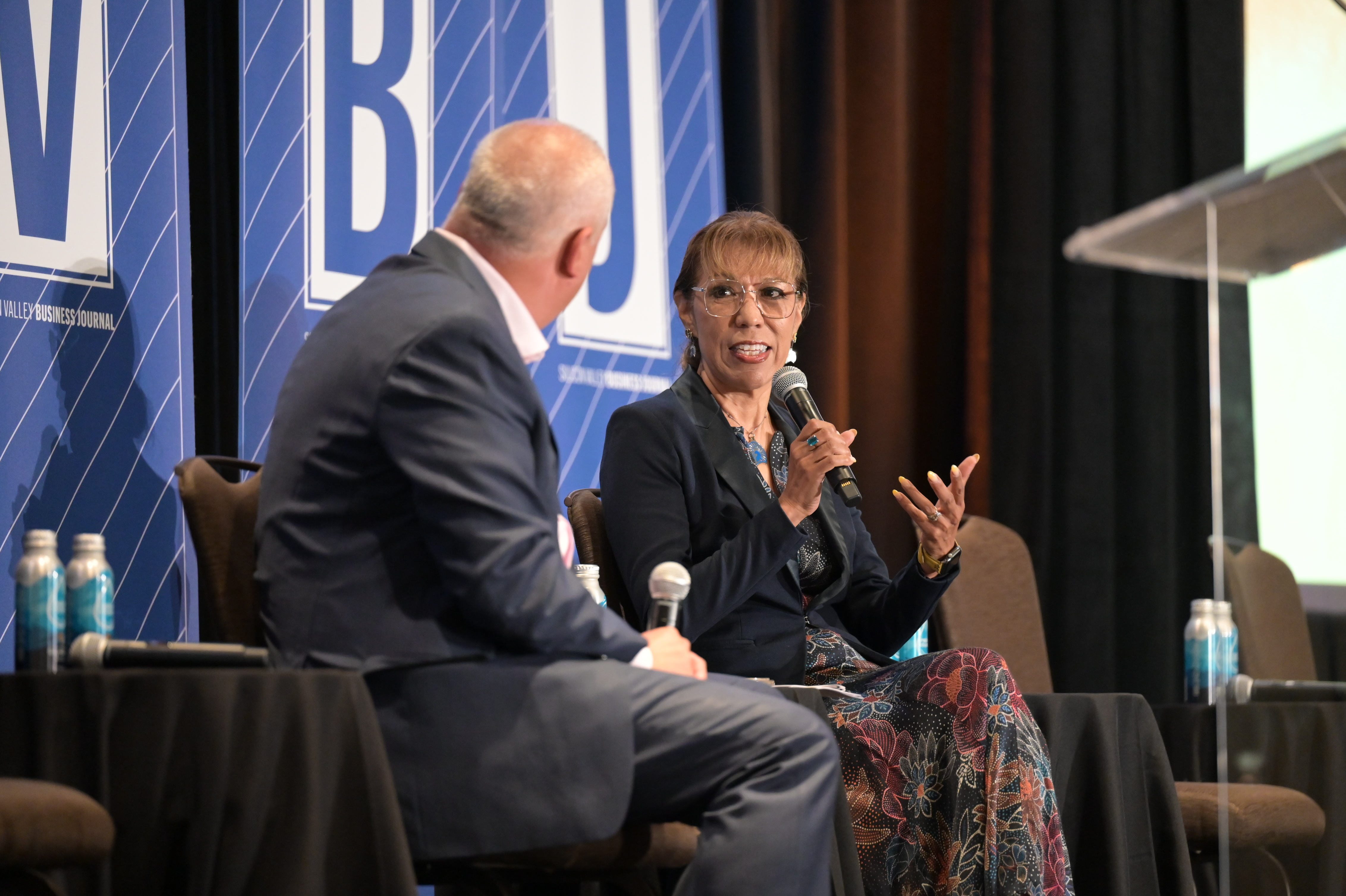 President Teniente-Matson speaking with a speaker at a Silicon Valley Business Journal sponsored event