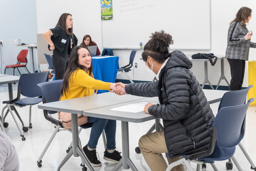 Student shaking hands with SJSU Staff