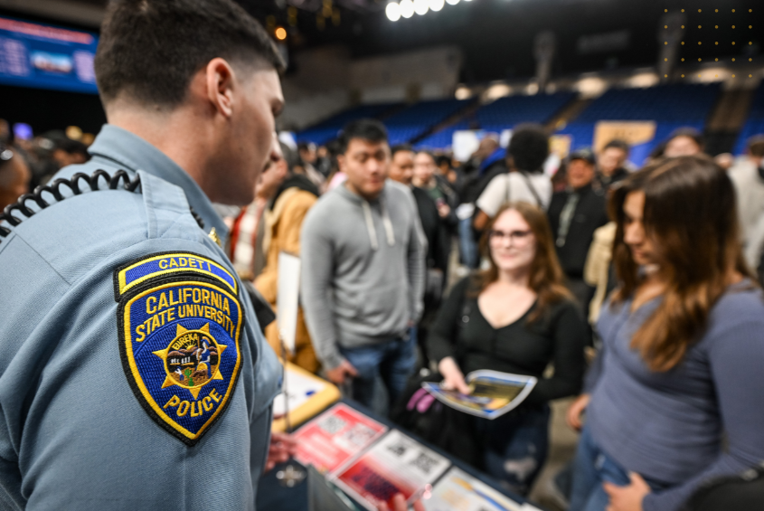 University Police Department cadet tabling in front of students at an event