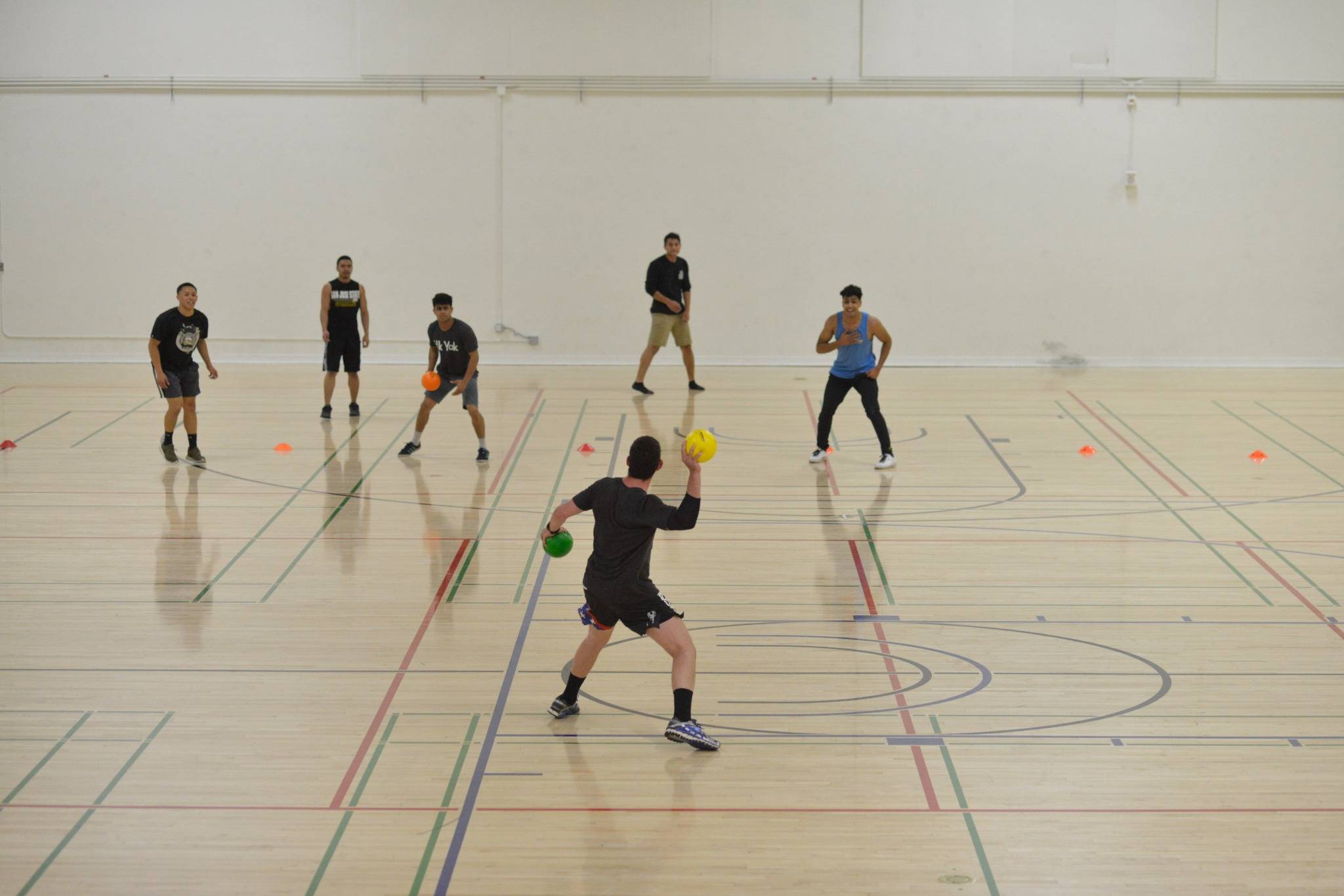 Couple of students playing dodgeball 